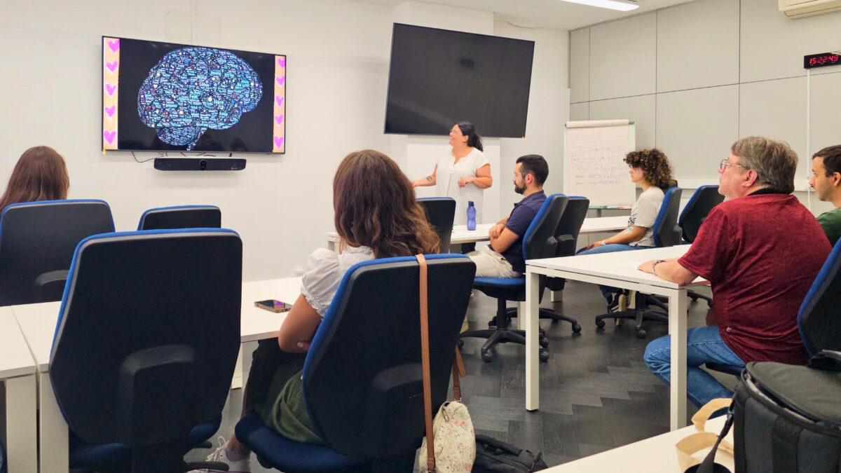 Carla Boura and group of PhD students sitting during a wellbeing the PhD Student Meetup workshop on mental health.